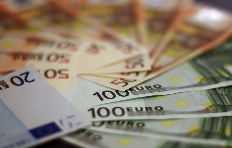 Close-up of various euro banknotes fanned out, symbolizing wealth and financial success